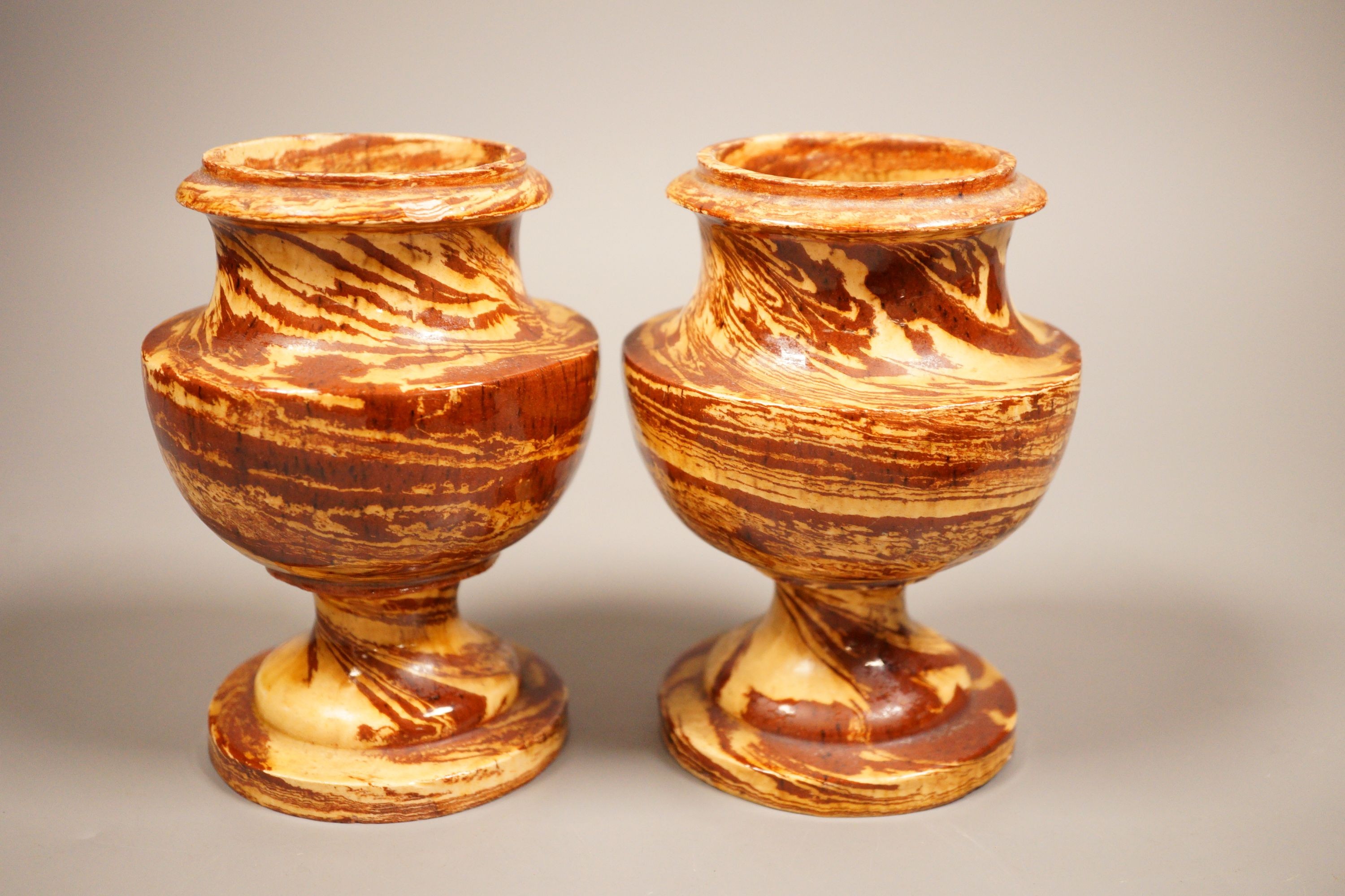 A pair of 19th century 'solid agate' pottery urns 14cm